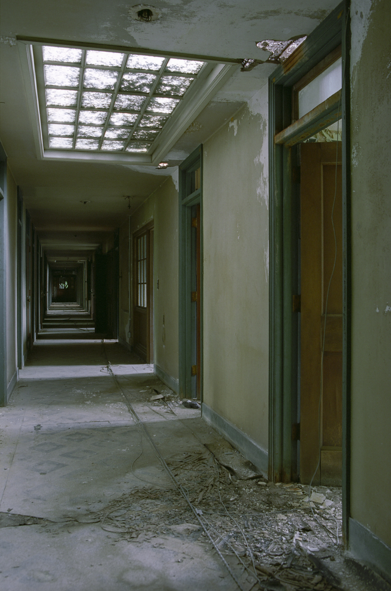 Doors to rooms in the male attendants' residence at Northampton State Hospital in a hall with sky lights