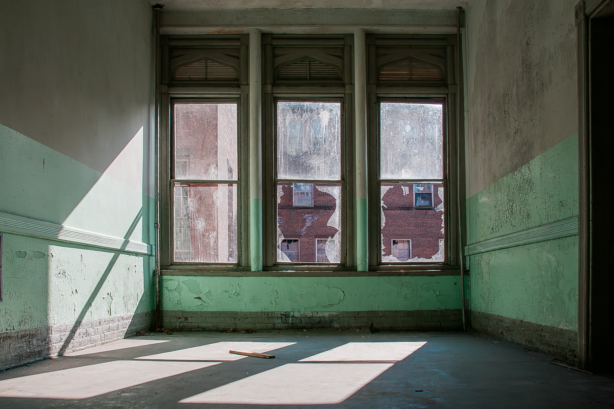 Hospital green ward with three windows at Northampton State Hospital.