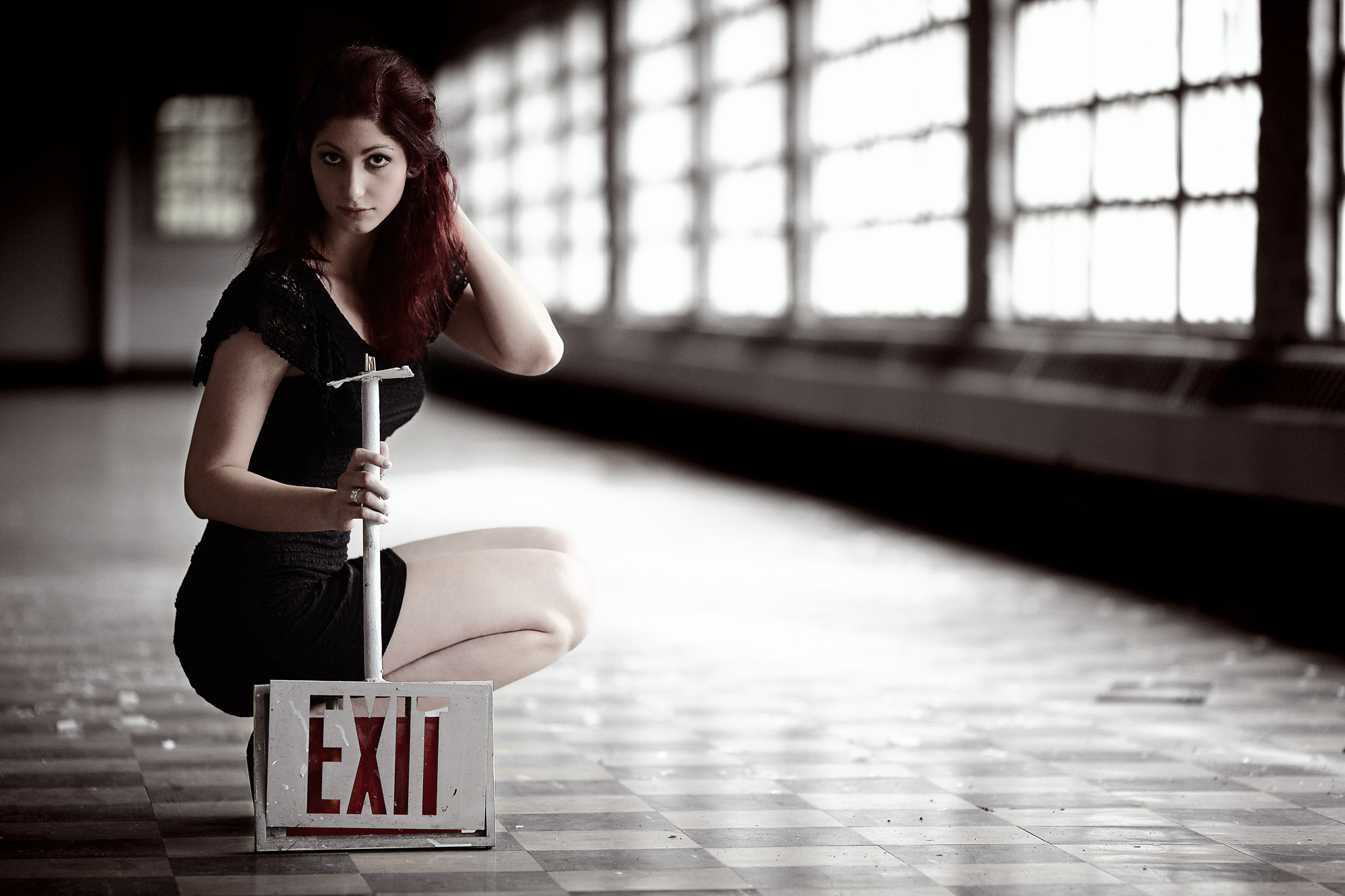 Model Geena holding an exit sign at Medfield State Hospital