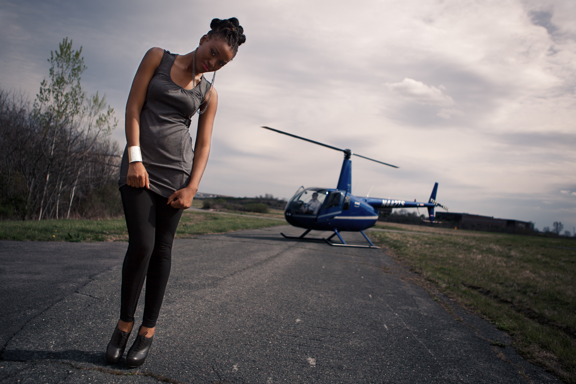 Model showing off DH Studios 2012 collection in front of a helicopter.