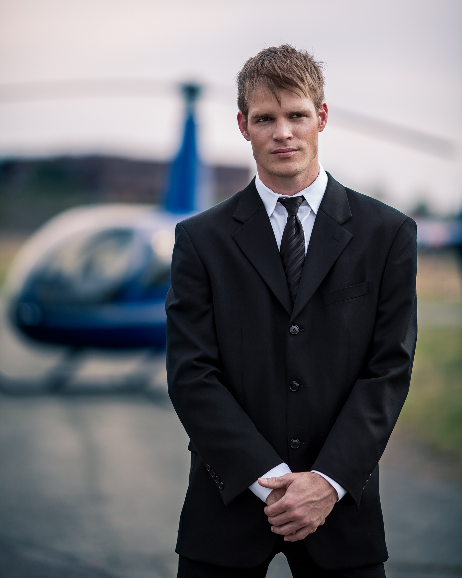 Model showing off DH Studios 2012 collection in front of a helicopter.
