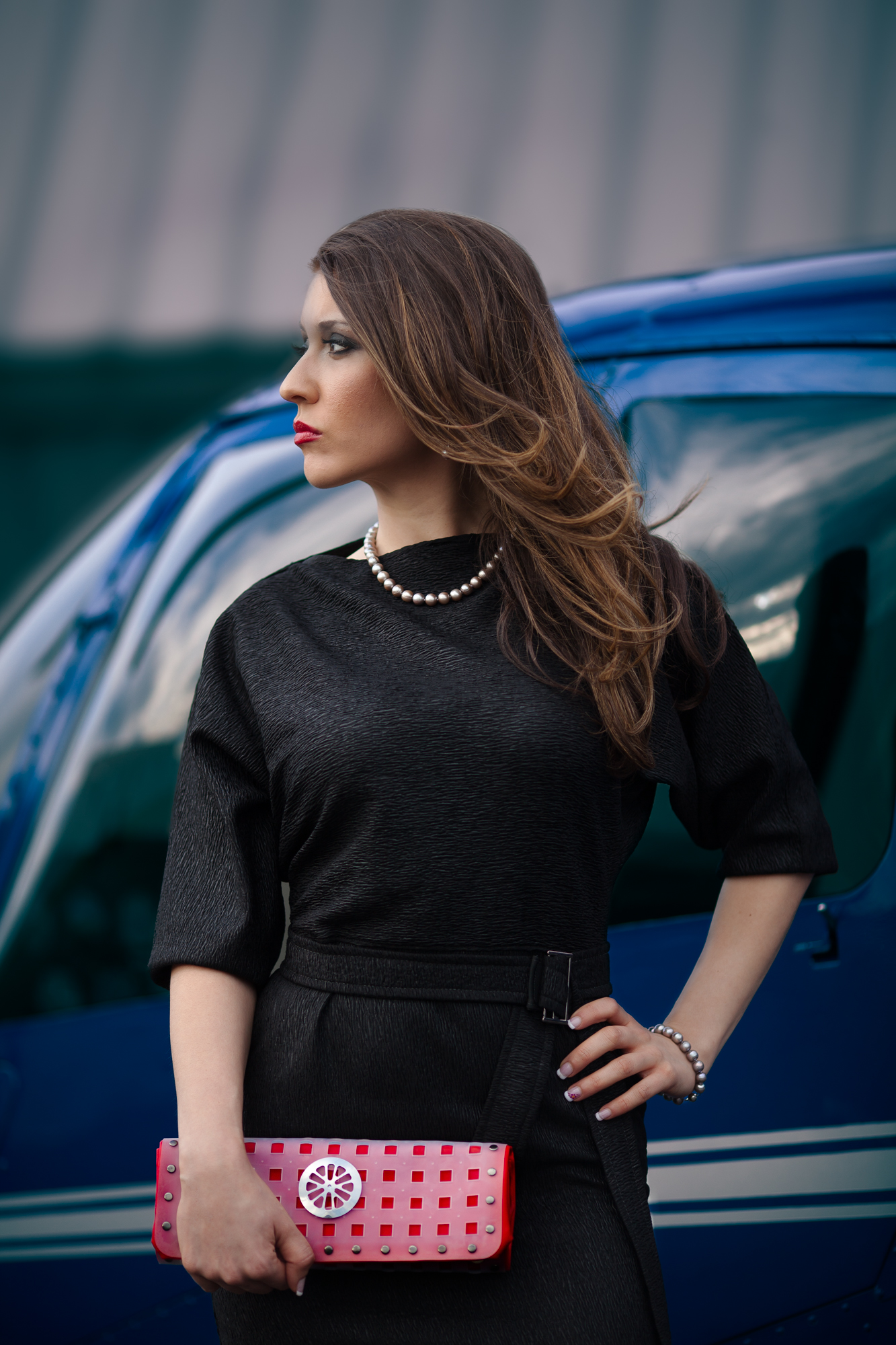 Model showing off DH Studios 2012 collection in front of a helicopter.