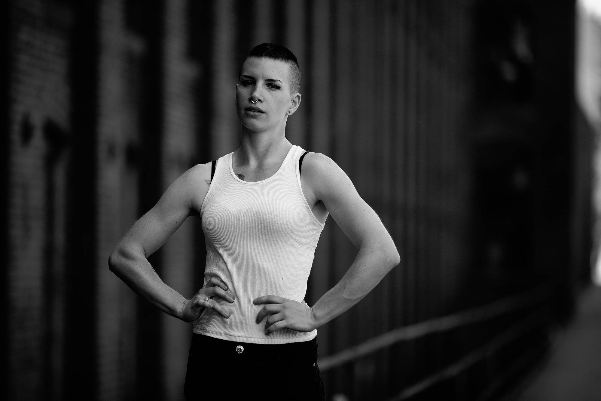 Black and white photo of model Lauren in front of a former mill building.