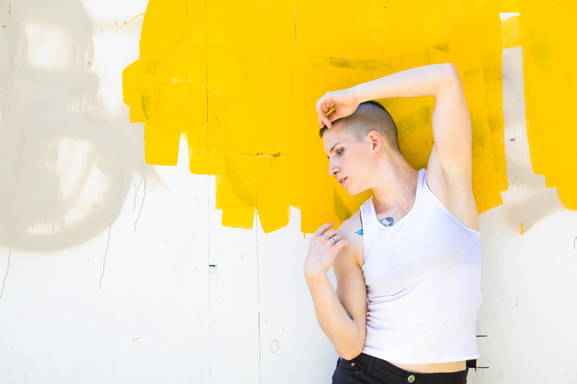 Model Lauren posing in front of a light colored wall.