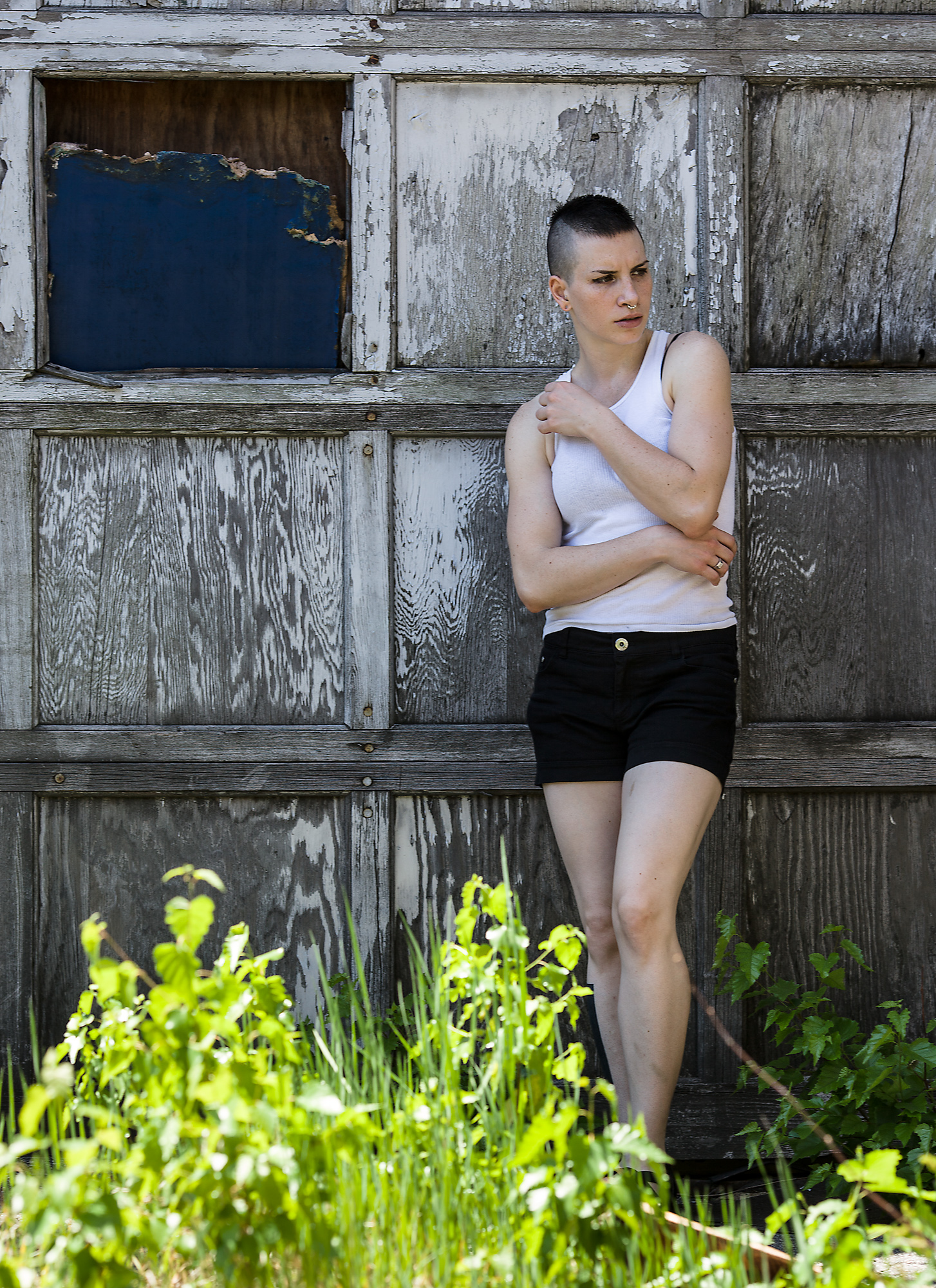 Model Lauren posing in front of a decaying garage door.