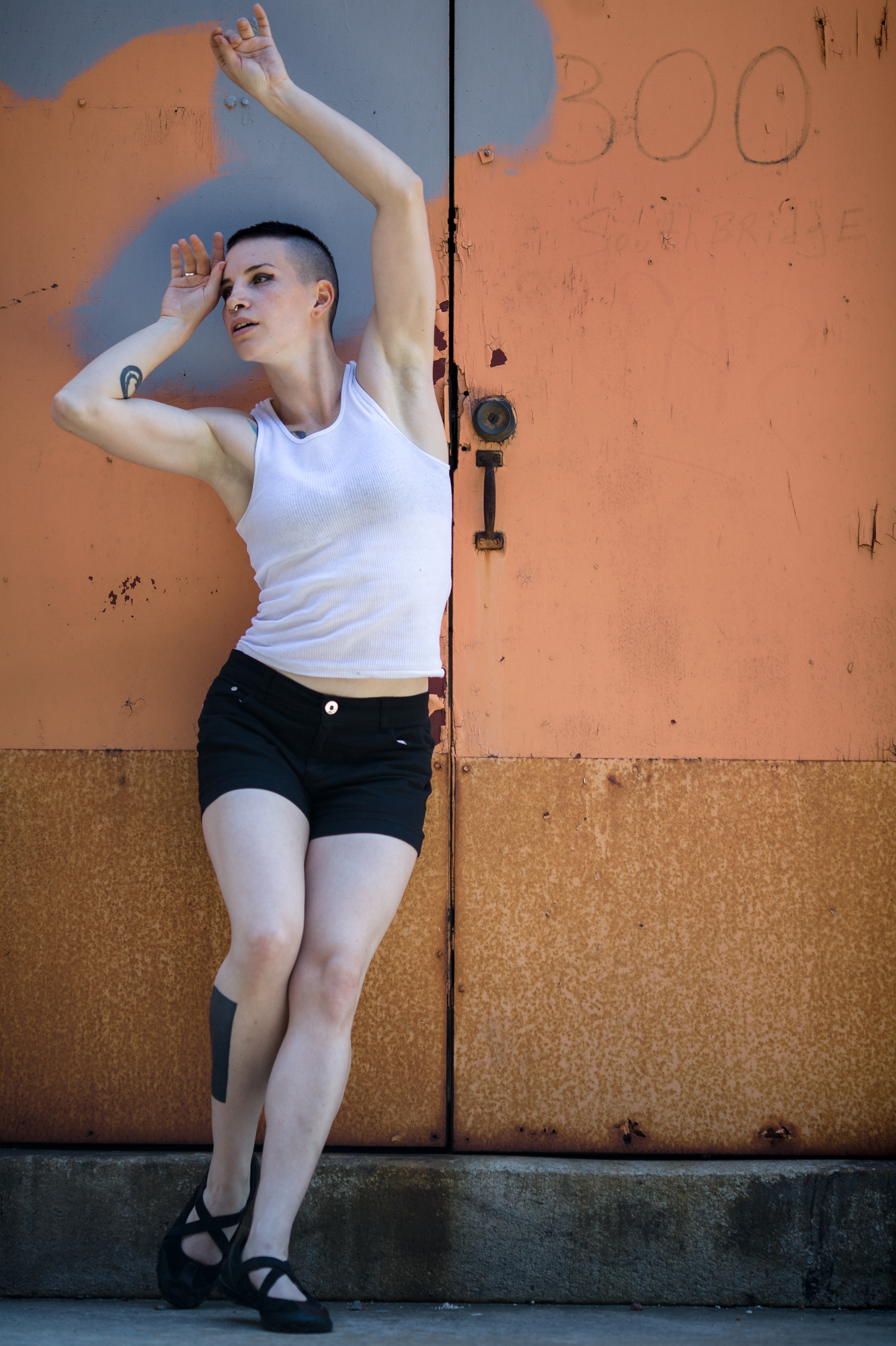 Model Lauren posing in front of a colorful set of doors.
