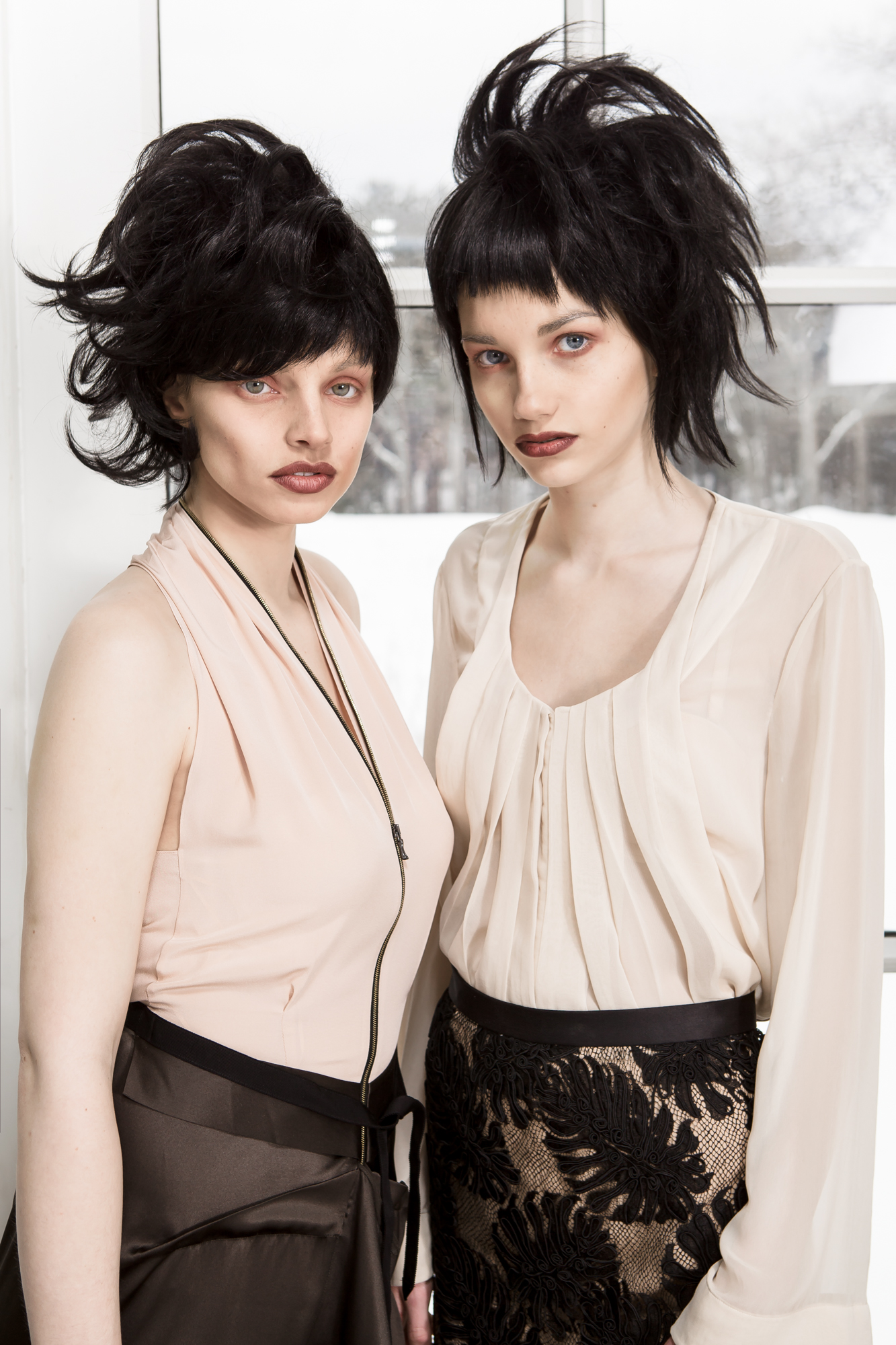 Two models posing in pieces from the DH Studios 2014 collection.