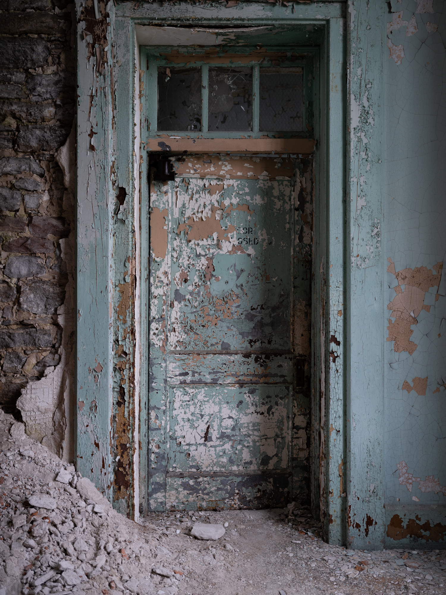 Hospital green doorway with crumbling plaster at Buffalo State Hospital