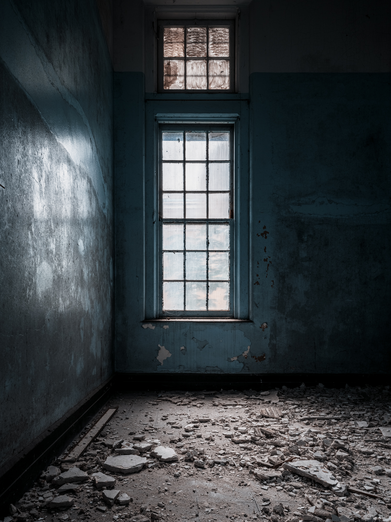 Dark crumbling patient room at Buffalo State Hospital