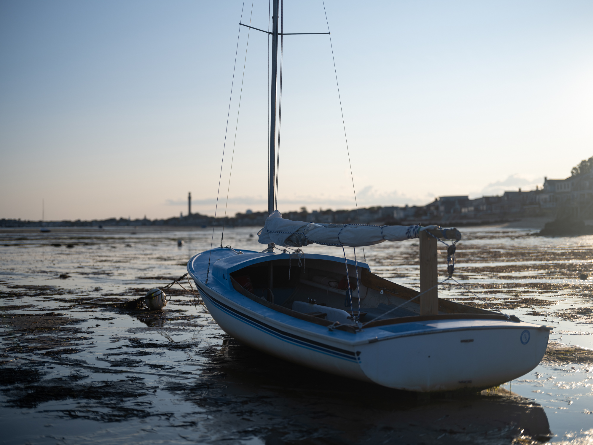 Image of a sailboat grounded at low tide in Provincetown, Massachusetts