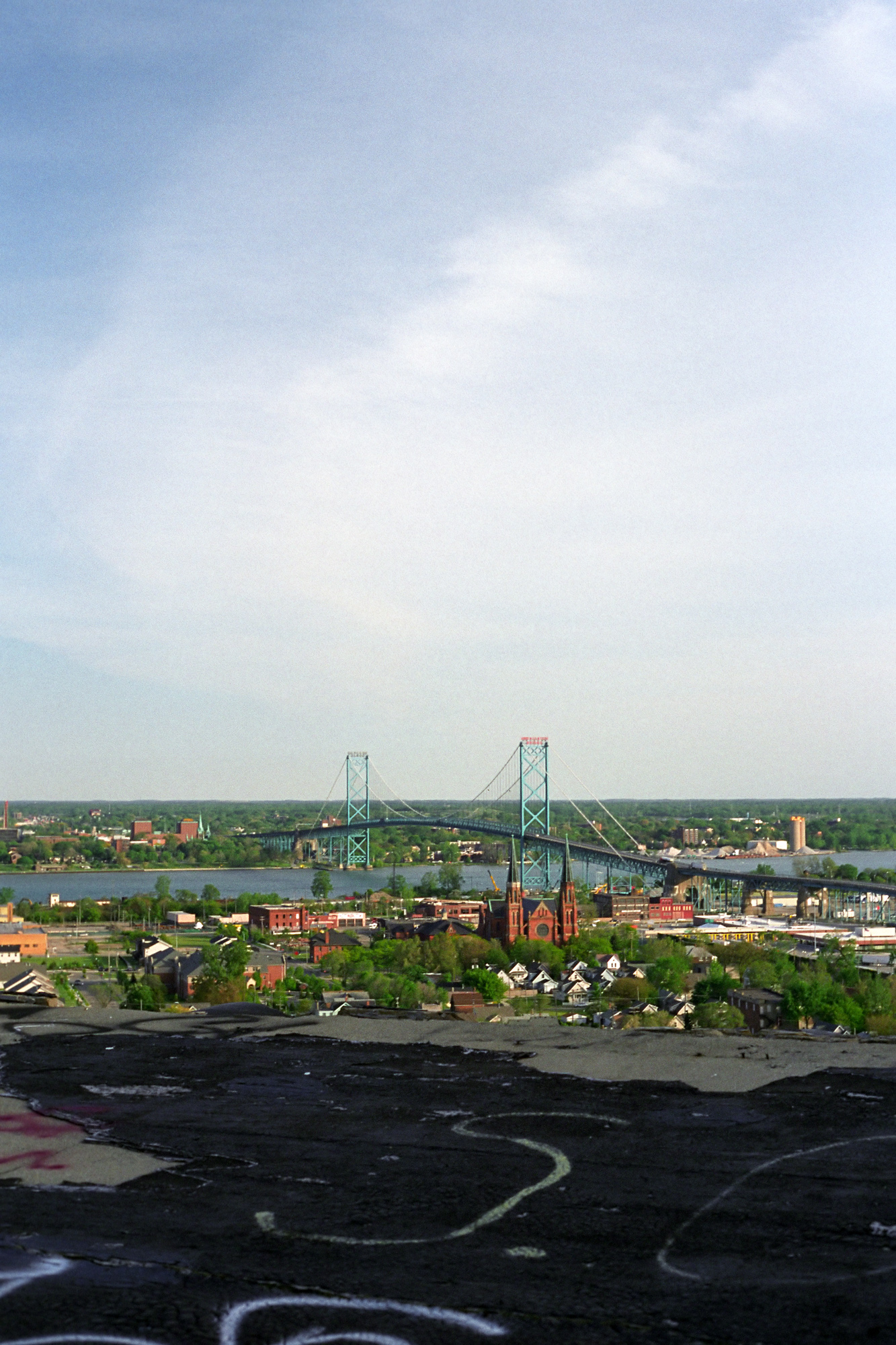 View of the Ambassador Bridge and Sweetest Heart of Mary cathedral from the roof of Michigan Central Station in Detroit, MI.